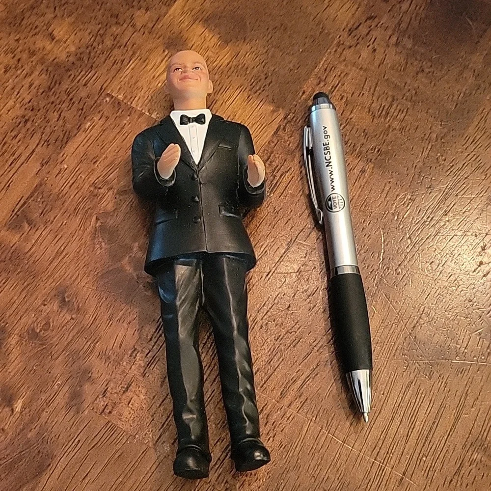 Cake topper African American groom. Bald in a tux